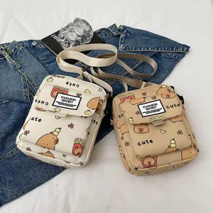 Cute cartoon capybara print canvas crossbody shoulder bag for women and students daily use.