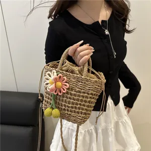 Summer woven bucket bag with cute flower charms, casual chic crossbody and handbag style.