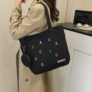 Canvas tote bag for women, large capacity shoulder bag with coin purse and colorful letters.