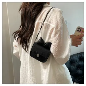 Black quilted crossbody bag with chain strap and elegant bow detail for women summer fashion.