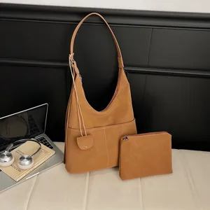 Brown suede hobo shoulder bag detail, stylish large capacity commuter tote with matching pouch.