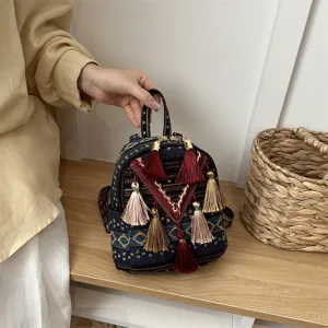 Ethnic woven mini backpack for women, stylish casual tassel daypack with top handle.