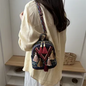 Ethnic style mini backpack for women, casual tassel design, versatile travel daypack.