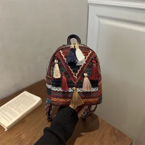 Ethnic bohemian woven mini backpack with colorful tassels for women casual daily use.
