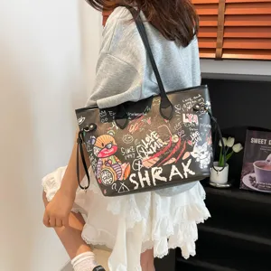 Stylish black graffiti tote bag for women, large capacity shoulder bag for daily commute.