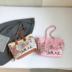 Stylish graffiti tote bag for women, large capacity shoulder bag with cute cartoon print for commute.