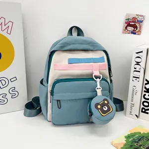 Cute cartoon kids backpack with bear pendant, lightweight and large capacity for school use.