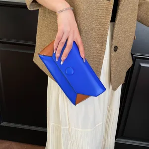 Chic color-blocked clutch bag featuring a stylish envelope fold and blue-brown contrast design.