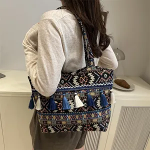 Ethnic style woven shoulder bag close-up showing intricate geometric patterns and tassel details.