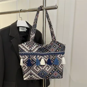 Ethnic woven tote bag with tassels, retro embroidered shoulder bag for commuting style.
