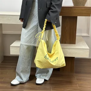 Casual yellow shoulder bag for women, lightweight tote with letter print, perfect for daily commute.