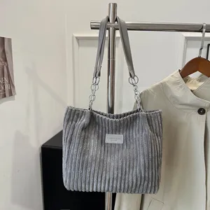 Grey corduroy shoulder tote bag with metal chain strap, casual large capacity handbag detail.