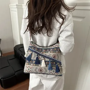 Ethnic style woven shoulder bag detail, vintage bohemian crossbody bag with chic tassels.