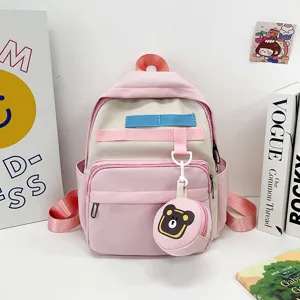 Pink cute cartoon kids backpack detail view with color webbing and cute bear coin pouch.