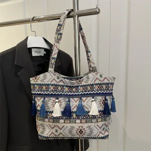 Ethnic style vintage woven shoulder bag with tassels, large capacity casual tote bag detail.