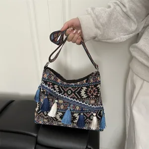 Ethnic style woven shoulder crossbody bag with geometric patterns and decorative tassels.