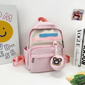 Pink and beige cute children school backpack with bear pendant, spacious multi-pocket design.
