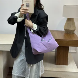 Casual purple shoulder bag with letter print, large capacity simple tote bag for daily commute.