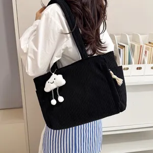 Black corduroy tote bag detail showing soft fabric, large capacity and cute cloud pendant.