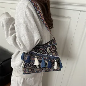 Ethnic style canvas shoulder bag detail, featuring geometric woven patterns and playful hanging tassels.