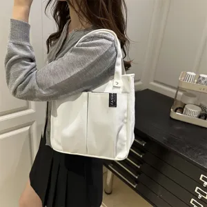 Detailansicht der weißen Canvas Tragetasche mit vielen Taschen für den täglichen Gebrauch.