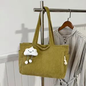 Corduroy tote bag for women large capacity retro shoulder handbag with cloud pendant.