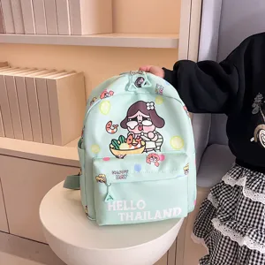 Close-up view of the cute cartoon printed light green school backpack showcasing fabric details.