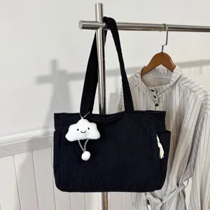 Close-up view of the black corduroy tote bag detail showcasing fabric texture and cute cloud charm.