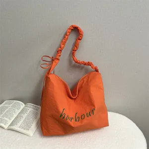 Casual nylon shoulder bag for women, large capacity orange tote bag with letter print.