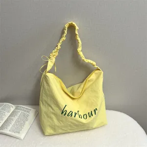 Yellow casual shoulder bag with letter print, large capacity commuter tote bag for women.