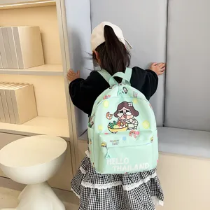 Detailed shot of a cute light green cartoon printed kids backpack, featuring side pockets and front pocket.