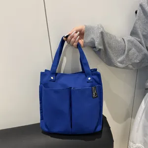 Blaue Canvas Tragetasche Detailansicht, Mehrfachtaschen Freizeit Handtasche für Alltag Arbeit Schule.
