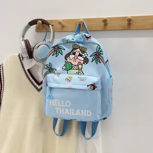 Detailed view of cute blue cartoon print kids backpack featuring front pocket and durable straps.