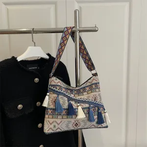 Ethnic style woven shoulder bag with geometric strap and decorative tassels for women fashion