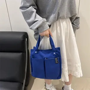 Blaue Canvas Tragetasche mit mehreren Taschen, praktische Freizeittasche für Arbeit & Alltag.