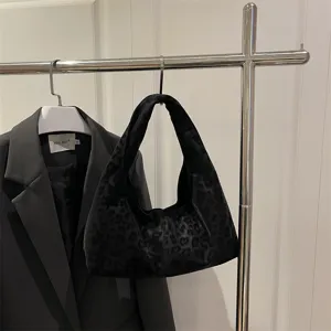Close-up view of the black leopard print hobo handbag showcasing its soft texture and lazy style.