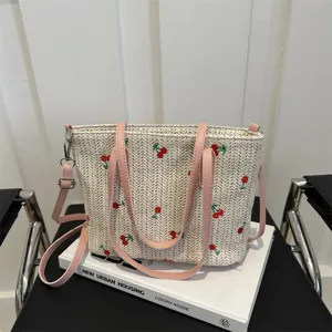 Summer straw woven tote bag with pink handles and cute cherry embroidery for daily travel.