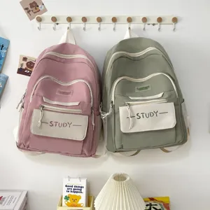 Casual canvas school backpack with multiple pockets in pink and green for students.