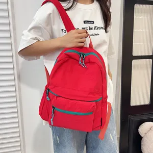 Casual minimalist large capacity red backpack with green zipper for students daily use.
