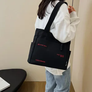 Large capacity black canvas tote bag for women students, stylish daily shoulder bag style.