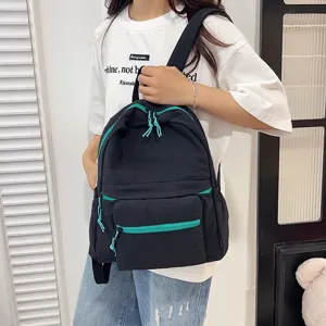 Casual black school backpack with vibrant teal zippers and multiple storage compartments daily use.