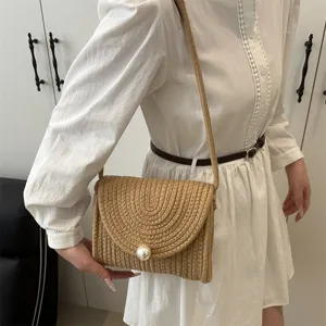 Handmade straw woven shoulder bag detail, sweet pearl clasp envelope crossbody design.