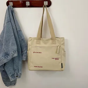 Casual canvas tote bag for women, large capacity daily shoulder bag with minimalist print.