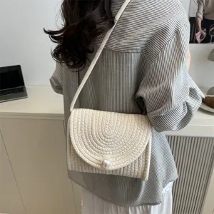 Handmade woven crossbody bag for women with elegant pearl closure, stylish retro envelope design.