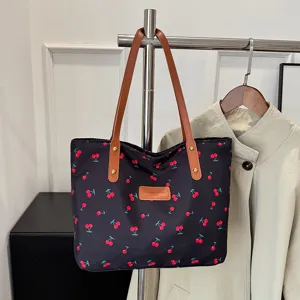 Black cherry print tote bag with brown leather handles for women daily work commuting style.