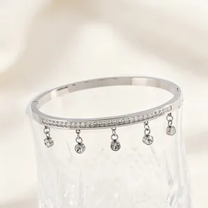 Titanium steel bracelet with single row crystals and hanging charms, elegant Korean style detail.