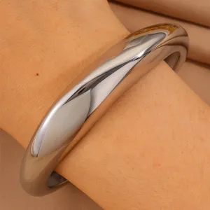 Stainless steel chunky irregular open bangle bracelet, polished silver finish, detail view.