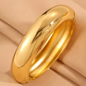 Chunky gold-plated stainless steel wide dome cuff bracelet detail closeup display view.