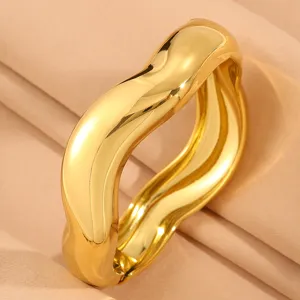 Detailed view of the wide irregular gold stainless steel open cuff bracelet, modern and chic.