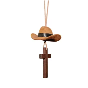 Close-up detail of retro wooden cross and mini cowboy hat car hanging ornament pendant.